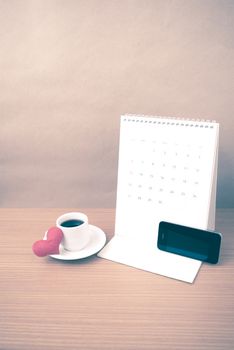 coffee,phone,calendar and heart on wood table background vintage style