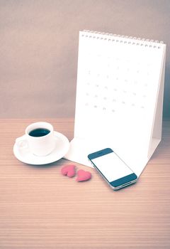 coffee,phone,calendar and heart on wood table background vintage style