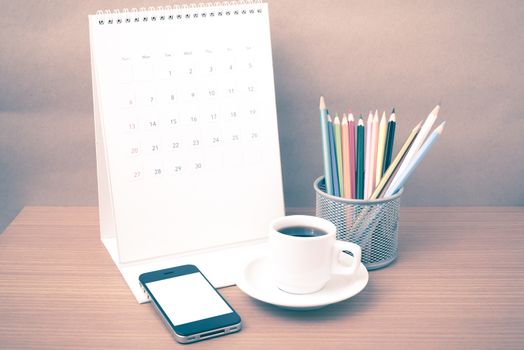 coffee,phone,calendar and color pencil on wood table background vintage style