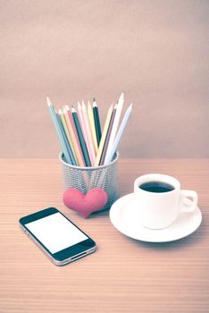 coffee,phone,color pencil and heart on wood table background vintage style