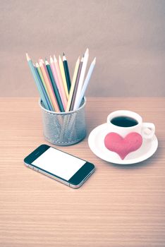 coffee,phone,color pencil and heart on wood table background vintage style