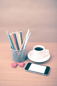 coffee,phone,color pencil and heart on wood table background vintage style