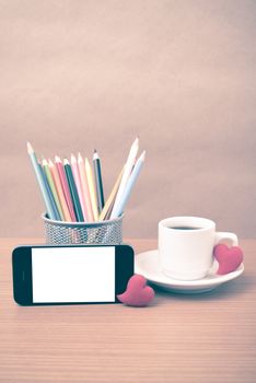 coffee,phone,color pencil and heart on wood table background vintage style