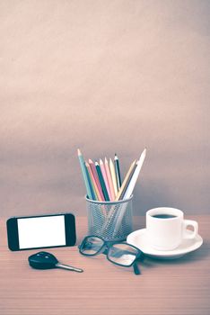 coffee,phone,eyeglasses,color pencil and car key on wood table background vintage style