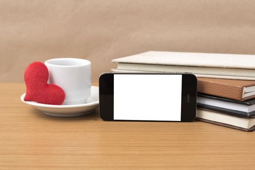 coffee,phone,stack of book and heart on wood table background