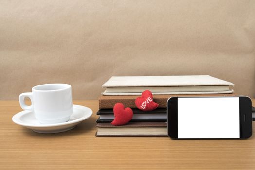 coffee,phone,stack of book and heart on wood table background