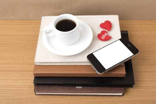 coffee,phone,stack of book and heart on wood table background