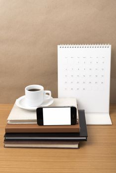 coffee,phone,stack of book and calendar on wood table background