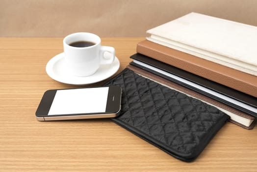 coffee,phone,stack of book and wallet on wood table background