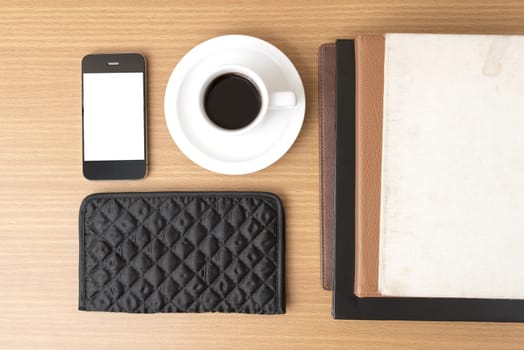 coffee,phone,stack of book and wallet on wood table background