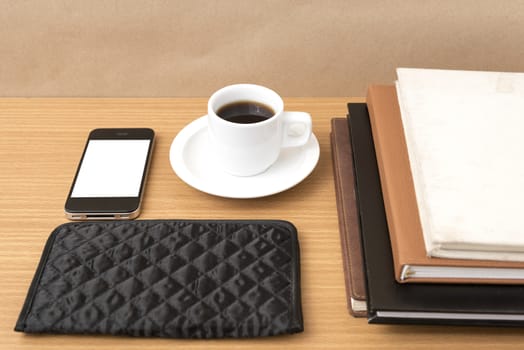 coffee,phone,stack of book and wallet on wood table background