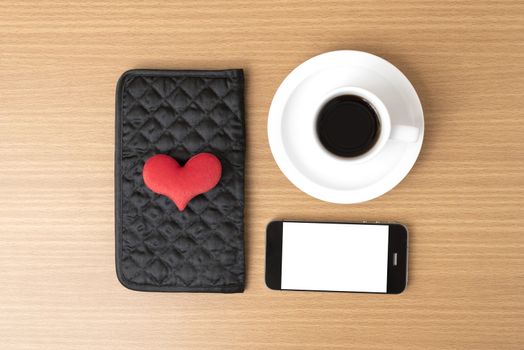 coffee,phone,wallet and heart on wood table background