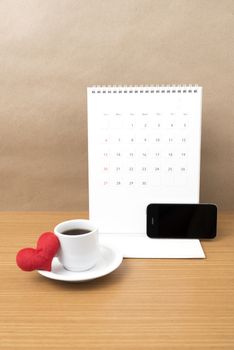 coffee,phone,calendar and heart on wood table background