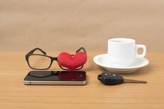coffee,phone,eyeglasses and car key on wood table background