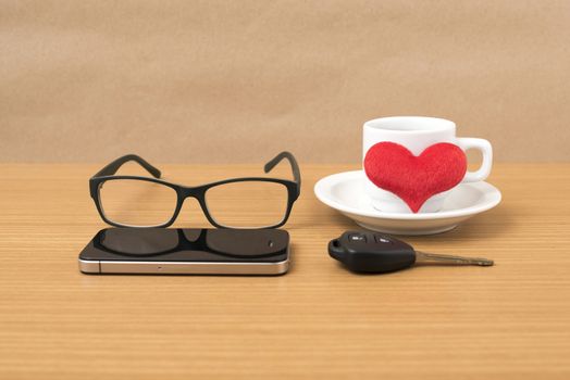 coffee,phone,eyeglasses and car key on wood table background