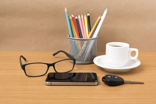coffee,phone,eyeglasses,color pencil and car key on wood table background
