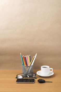 coffee,phone,eyeglasses,color pencil and car key on wood table background