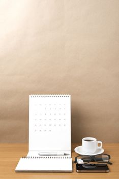 coffee,phone,eyeglasses,notepad and canlendar on wood table background