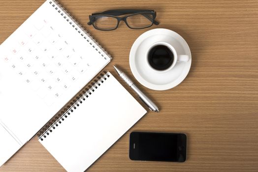 coffee,phone,eyeglasses,notepad and canlendar on wood table background