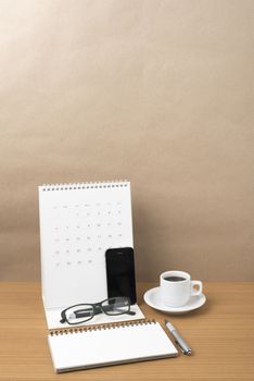 coffee,phone,eyeglasses,notepad and canlendar on wood table background