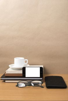 coffee,phone,eyeglasses,stack of book and wallet on wood table background