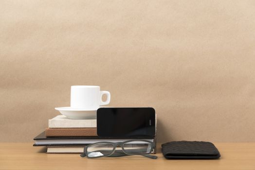 coffee,phone,eyeglasses,stack of book and wallet on wood table background