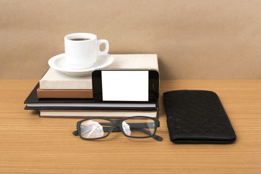 coffee,phone,eyeglasses,stack of book and wallet on wood table background