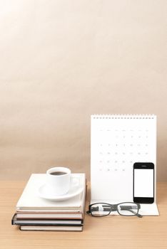 coffee,phone,eyeglasses,stack of book and calendar on wood table background