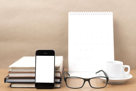 coffee,phone,eyeglasses,stack of book and calendar on wood table background
