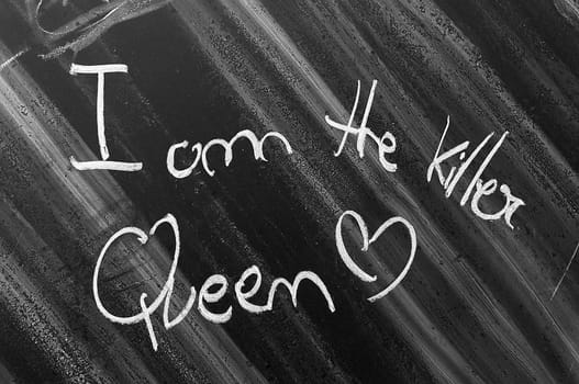 I am the killer Queen written on a chalkboard