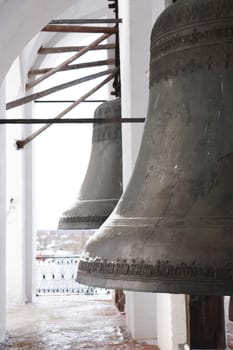 Old Russian church. Closeup of big ancient bronze bells on belfry