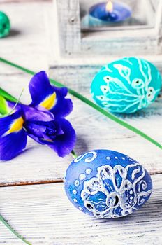 Decorated with painted Easter eggs and flowers on a light background