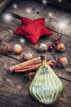Christmas decoration,hazelnuts,cinnamon and star anise on wooden background.