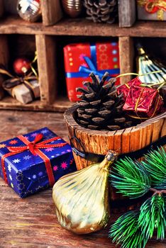 Spruce ,wooden bucket with heater and gifts on the background of Christmas decorations