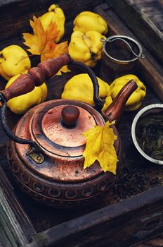 Copper kettle,the fruit of the quince in wooden box in the fall