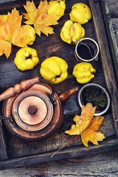 Copper kettle,the fruit of the quince in wooden box in the fall