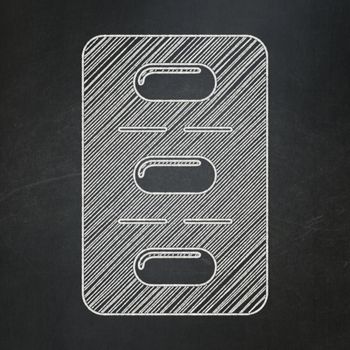 Medicine concept: Pills Blister icon on Black chalkboard background