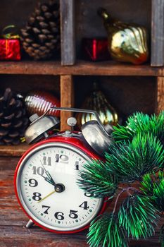 Clock alarm clock with bells on the background of Christmas decorations