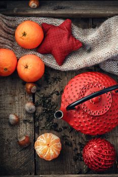 Red tea,tangerines,hazelnuts and scattered tea leaves.Top view