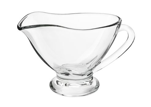 Empty clear glass gravy boat isolated on a white background.
