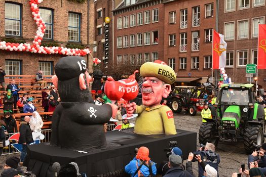 GERMANY, Düsseldorf: A carnival float depicting Turkish President Recep Tayyip Erdogan (R) clinking his glass with a fighter of the Islamic State (IS) terrorist organization (L) stands in front of the city hall in Düsseldorf, western Germany, after the Rose Monday (Rosenmontag) street parade has been cancelled on February 8, 2016. Traditional Rose Monday carnival parades in several western German cities have been cancelled due to stormy weather.
