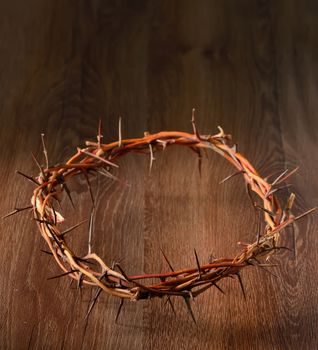 Crown of thorns on wooden background