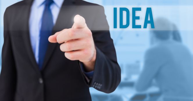 The word idea and businessman pointing his finger at camera against blue background