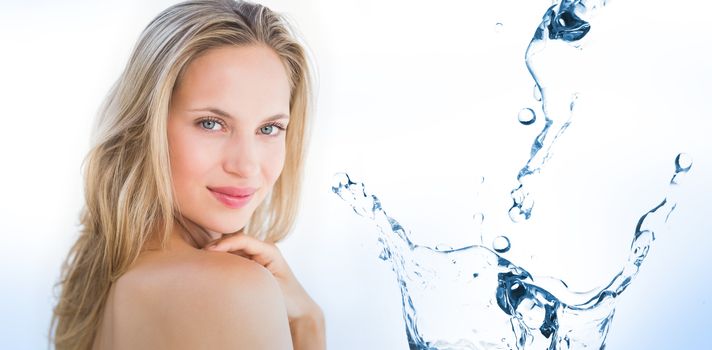 Water bubbling on white surface against pretty blonde sitting on massage table