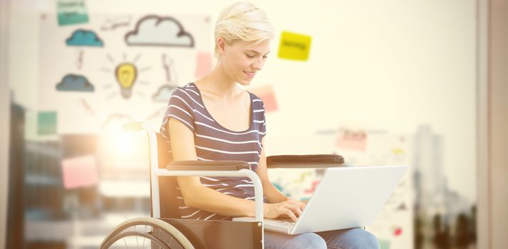 Woman in wheelchair using computer against adhesive notes on window 