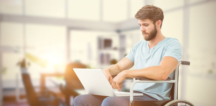 Man in wheelchair using computer against board room