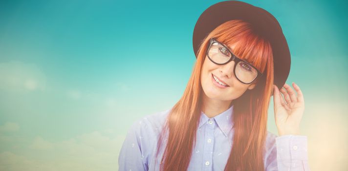 Smiling hipster woman posing face to the camera against blue green background