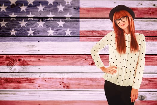 Portrait of a smiling hipster woman against composite image of usa national flag