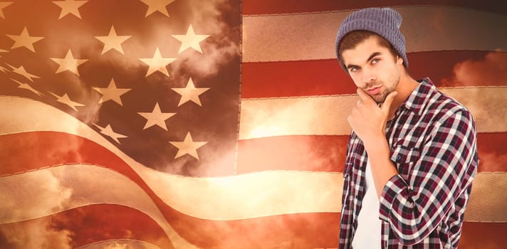 Thoughtful man against white background against composite image of digitally generated united states national flag