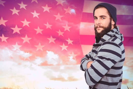 Portrait of confident hipster with hooded shirt against composite image of united states of america flag